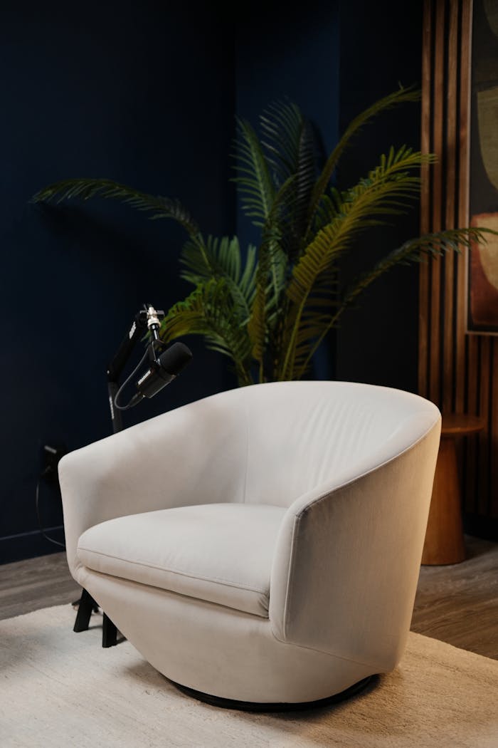 Chic and moody podcast studio setup in Montreal with elegant white accent chair.