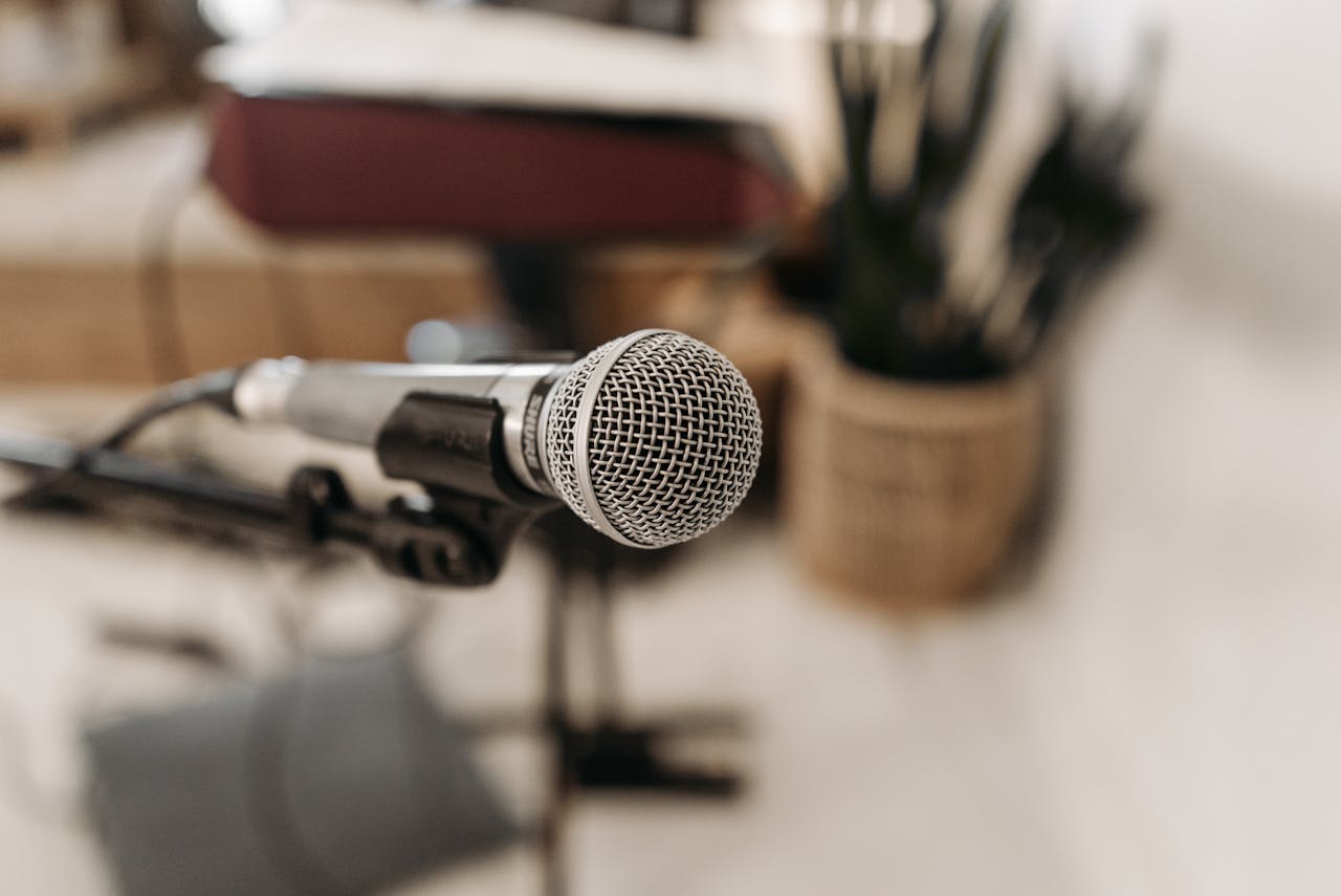 Close-up of a microphone in a studio setting, ready for sound recording.